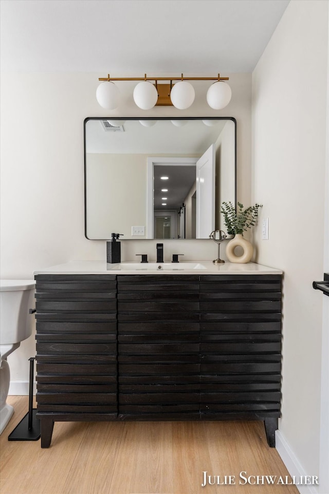 751 Old Gate Rd NW, Grand Rapids, MI 49504 - full bath with double vanity and wood finished floors