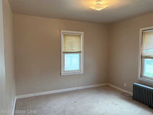 5873 Elmgrove Ave, Warren, MI 48092 - empty room featuring radiator heating unit and light colored carpet