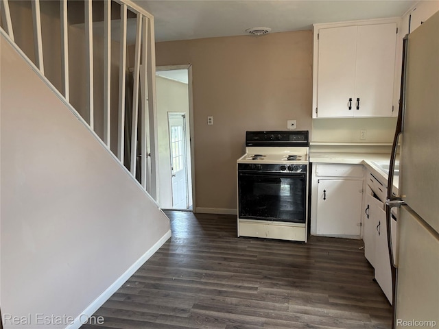 5873 Elmgrove Ave, Warren, MI 48092 - kitchen with white electric range oven, freestanding refrigerator, dark wood-style flooring, white cabinets, and light countertops