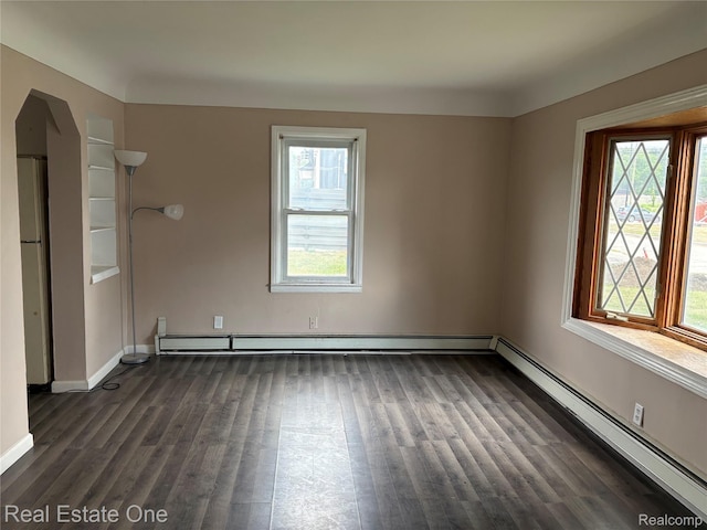 5873 Elmgrove Ave, Warren, MI 48092 - empty room with a baseboard radiator, dark wood finished floors, and healthy amount of natural light