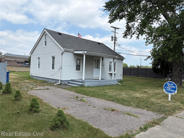 5873 Elmgrove Ave, Warren, MI 48092 - view of front of home with a porch, a chimney, and roof with shingles