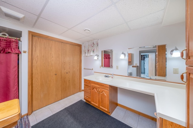 616 N Lincoln Ave, Lakeview, MI 48850 - bathroom featuring a drop ceiling, tile patterned flooring, vanity, and a shower with curtain