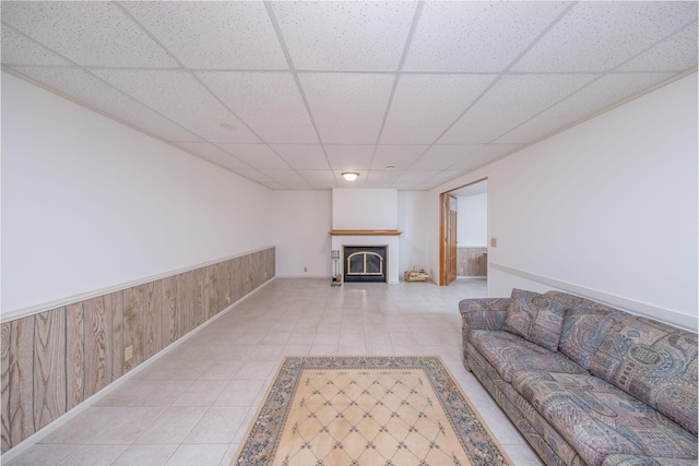 616 N Lincoln Ave, Lakeview, MI 48850 - living room featuring a drop ceiling, a fireplace, light tile patterned floors, and a wainscoted wall