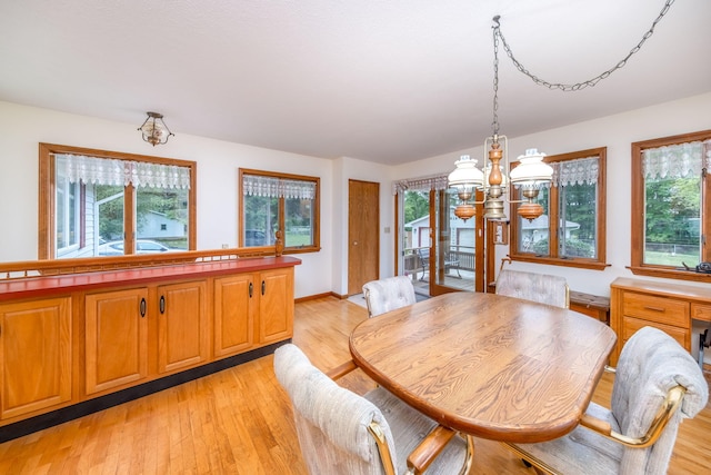 616 N Lincoln Ave, Lakeview, MI 48850 - dining space with a chandelier, light wood-style flooring, and healthy amount of natural light