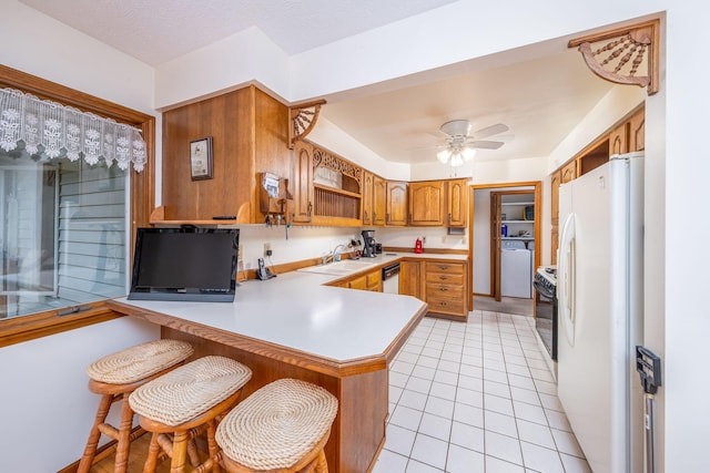 616 N Lincoln Ave, Lakeview, MI 48850 - kitchen featuring white appliances, a peninsula, open shelves, brown cabinets, and light countertops