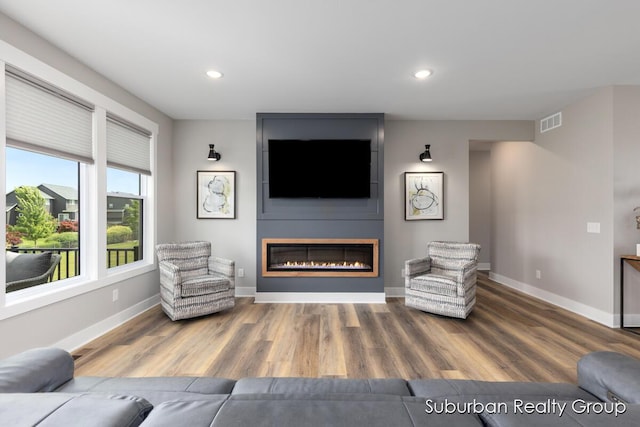 8056 Tramway Dr SW, Byron Center, MI 49315 - living room with a fireplace, wood finished floors, and recessed lighting
