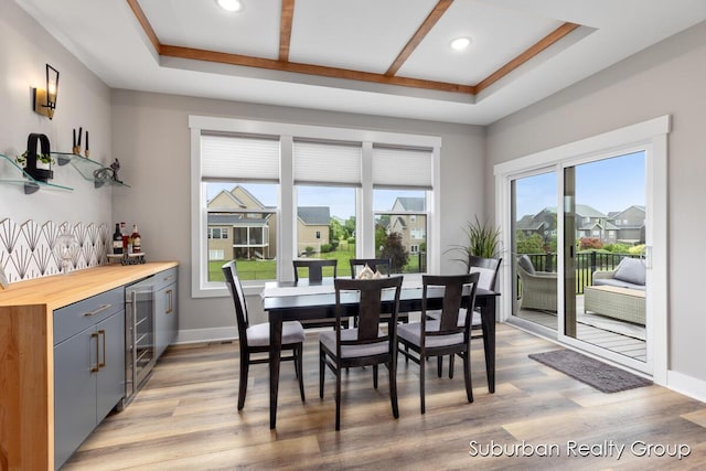 8056 Tramway Dr SW, Byron Center, MI 49315 - dining area featuring beverage cooler, light wood-style floors, a bar, and recessed lighting