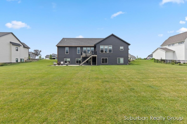 8056 Tramway Dr SW, Byron Center, MI 49315 - rear view of house with stairs, a yard, a wooden deck, and a residential view