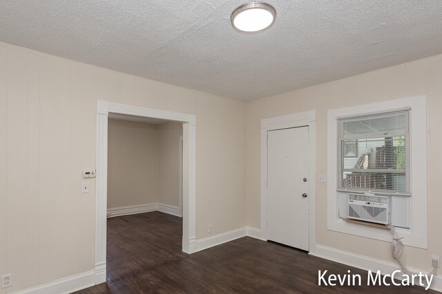 214 Bradford St NE, Grand Rapids, MI 49503 - foyer entrance with dark wood-style floors, a textured ceiling, and cooling unit