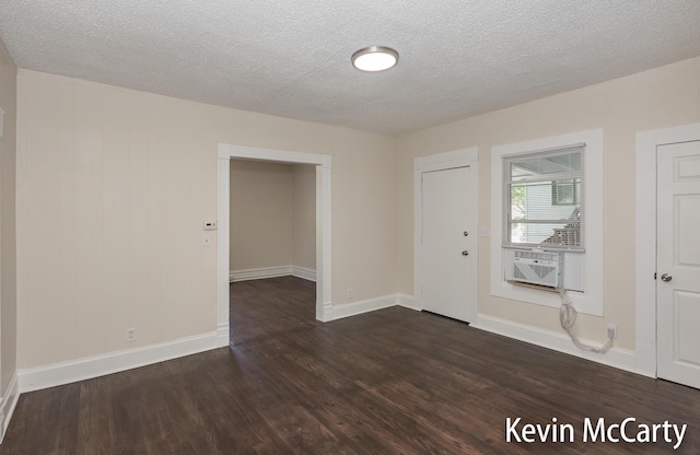 214 Bradford St NE, Grand Rapids, MI 49503 - foyer entrance featuring dark wood-type flooring, cooling unit, and a textured ceiling