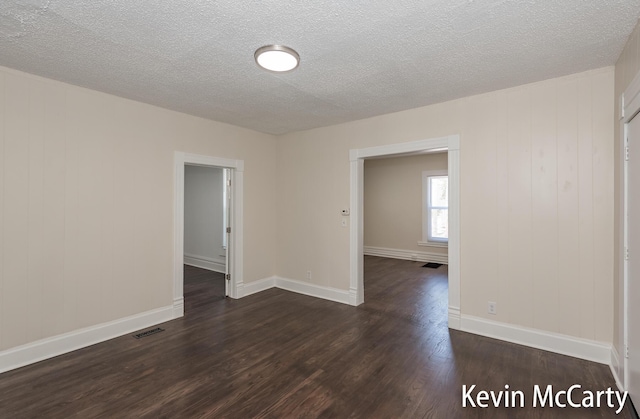 214 Bradford St NE, Grand Rapids, MI 49503 - spare room with dark wood finished floors and a textured ceiling