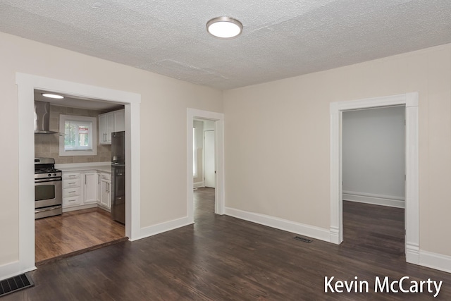214 Bradford St NE, Grand Rapids, MI 49503 - spare room with dark wood-style flooring and a textured ceiling
