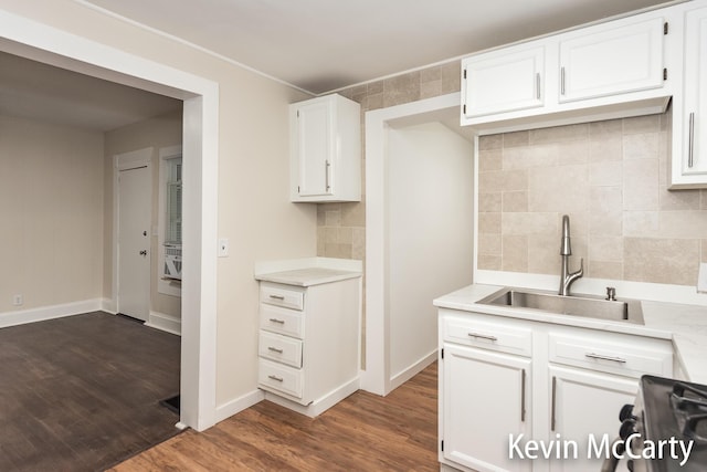214 Bradford St NE, Grand Rapids, MI 49503 - kitchen with light countertops, tasteful backsplash, white cabinetry, and stove