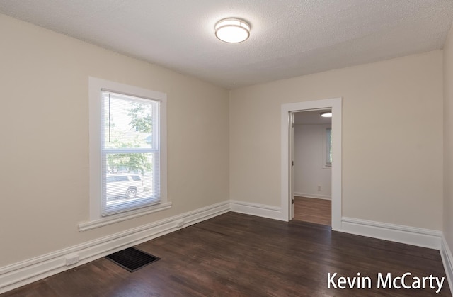 214 Bradford St NE, Grand Rapids, MI 49503 - unfurnished room featuring dark wood-style floors and a textured ceiling