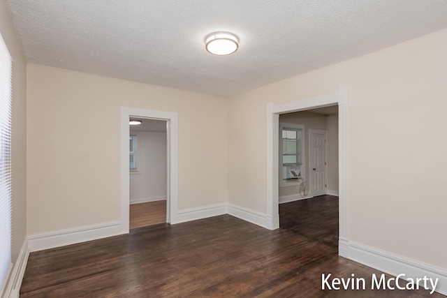 214 Bradford St NE, Grand Rapids, MI 49503 - empty room with dark wood-style flooring and a textured ceiling