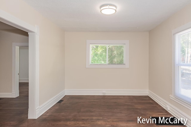 214 Bradford St NE, Grand Rapids, MI 49503 - empty room featuring plenty of natural light and wood finished floors