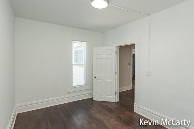214 Bradford St NE, Grand Rapids, MI 49503 - spare room with dark wood-style floors and baseboards