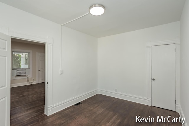 214 Bradford St NE, Grand Rapids, MI 49503 - spare room with dark wood-style flooring and cooling unit