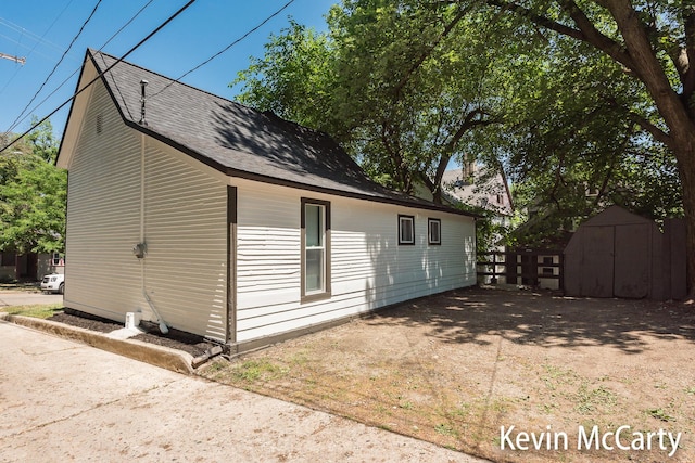214 Bradford St NE, Grand Rapids, MI 49503 - view of side of property with a storage shed and a shingled roof