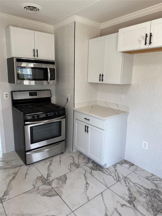 147 Euclid St, Mount Clemens, MI 48043 - kitchen with stainless steel appliances, ornamental molding, white cabinets, light marble finish flooring, and light stone counters