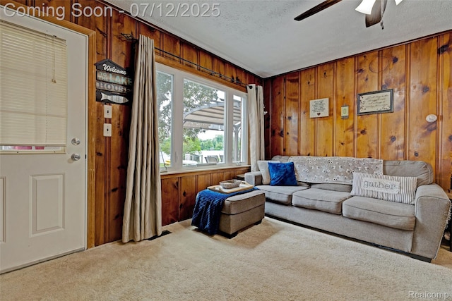 1962 Lake Pointe Dr, Ortonville, MI 48462 - carpeted living area with wood walls, ceiling fan, and a textured ceiling