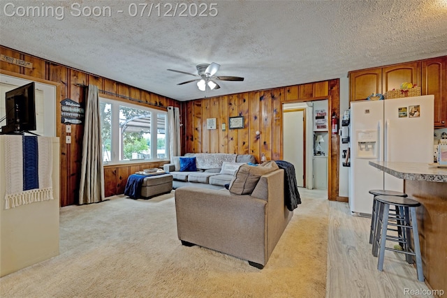1962 Lake Pointe Dr, Ortonville, MI 48462 - living room with wood walls, ceiling fan, a textured ceiling, and light carpet