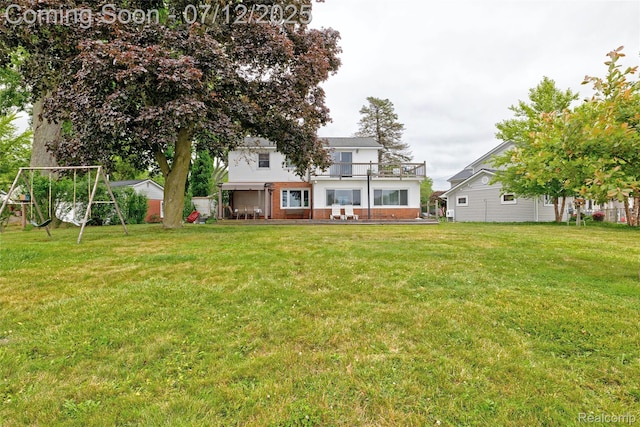 1962 Lake Pointe Dr, Ortonville, MI 48462 - back of house featuring a lawn and a playground