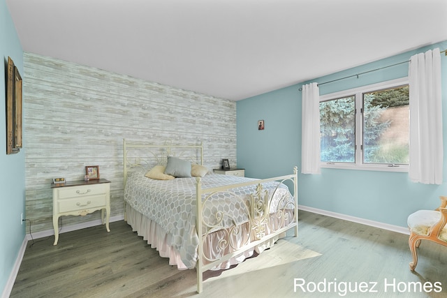 2106 Cranbrook Dr NE, Grand Rapids, MI 49505 - bedroom with an accent wall and wood finished floors
