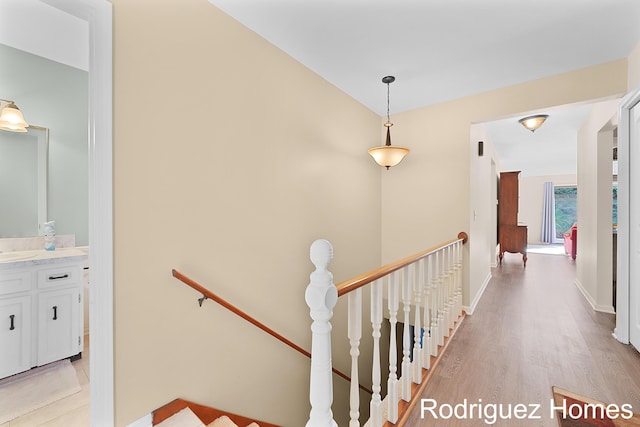 2106 Cranbrook Dr NE, Grand Rapids, MI 49505 - hallway featuring an upstairs landing and light wood-type flooring