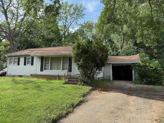 6429 Wendell St SE, Grand Rapids, MI 49546 - view of front of house featuring dirt driveway, a front yard, a porch, a garage, and a chimney