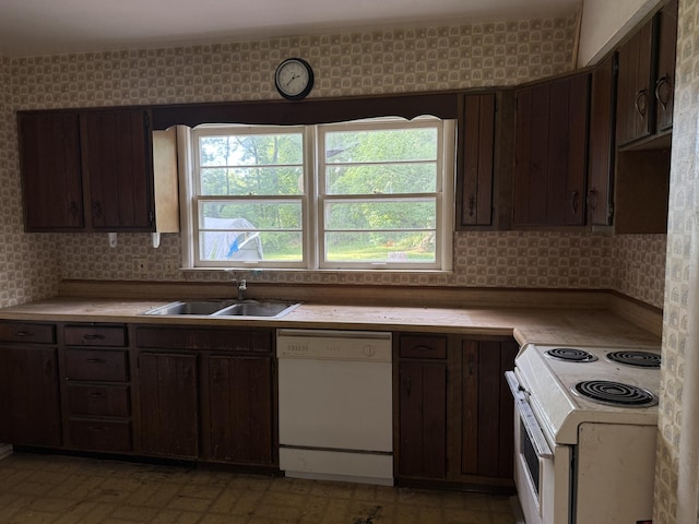 6429 Wendell St SE, Grand Rapids, MI 49546 - kitchen featuring white appliances, light countertops, dark brown cabinets, and wallpapered walls