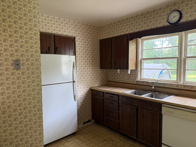 6429 Wendell St SE, Grand Rapids, MI 49546 - kitchen featuring white appliances, dark brown cabinets, light countertops, and wallpapered walls