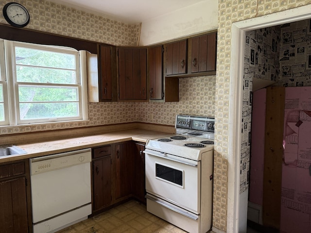 6429 Wendell St SE, Grand Rapids, MI 49546 - kitchen featuring white appliances, light countertops, wallpapered walls, and dark brown cabinetry