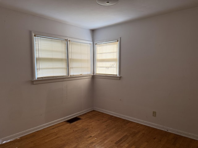 6429 Wendell St SE, Grand Rapids, MI 49546 - empty room with healthy amount of natural light and wood finished floors