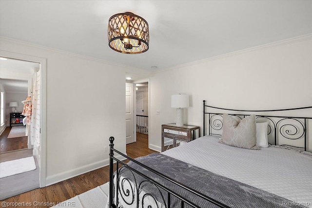 586 Fairfax St, Birmingham, MI 48009 - bedroom featuring wood finished floors, ornamental molding, and a chandelier