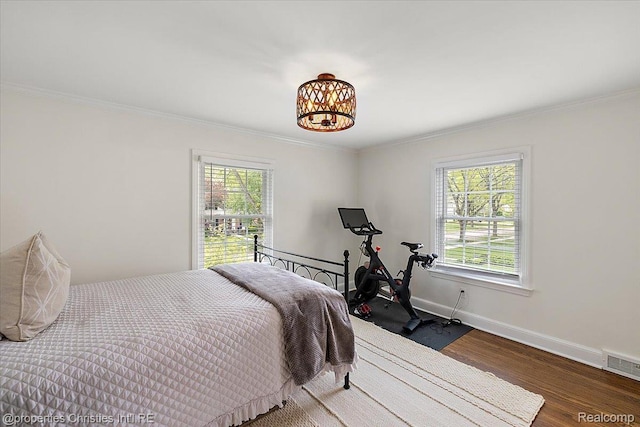 586 Fairfax St, Birmingham, MI 48009 - bedroom with multiple windows, wood finished floors, crown molding, and a chandelier