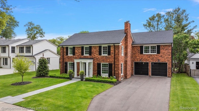 586 Fairfax St, Birmingham, MI 48009 - view of front of house featuring asphalt driveway, an attached garage, a chimney, and brick siding