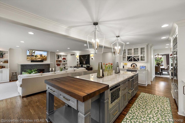 586 Fairfax St, Birmingham, MI 48009 - kitchen with wood counters, white cabinets, glass insert cabinets, dark wood-type flooring, and recessed lighting