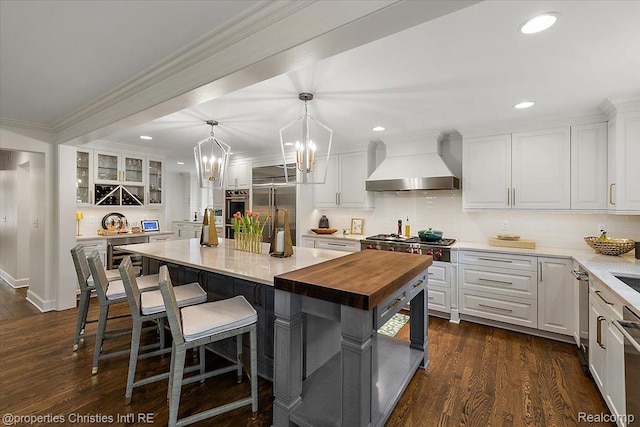 586 Fairfax St, Birmingham, MI 48009 - kitchen featuring custom range hood, stainless steel appliances, butcher block countertops, white cabinets, and recessed lighting
