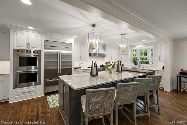 586 Fairfax St, Birmingham, MI 48009 - kitchen featuring appliances with stainless steel finishes, a chandelier, tasteful backsplash, crown molding, and white cabinets