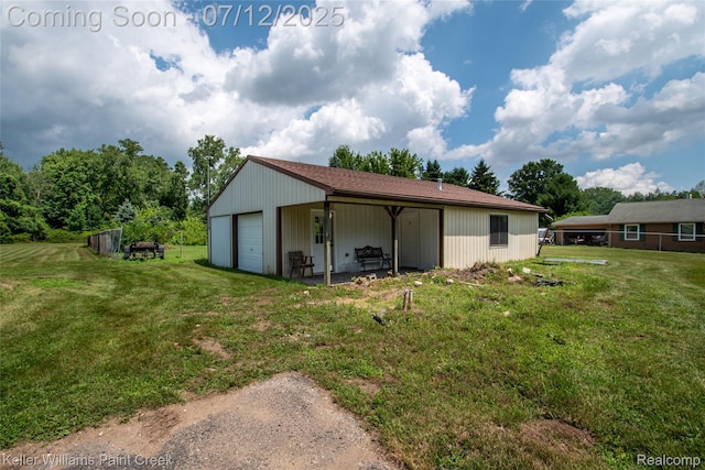 20525 30 Mile Rd, Ray, MI 48096 - back of house with a detached garage, a lawn, and an outbuilding