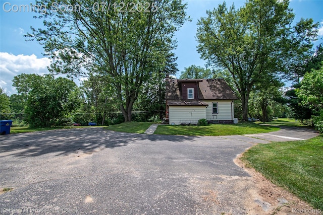 20525 30 Mile Rd, Ray, MI 48096 - view of front of house with a chimney, a front yard, and a shingled roof