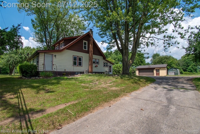 20525 30 Mile Rd, Ray, MI 48096 - view of front facade featuring a detached garage, an outdoor structure, a chimney, and a front yard