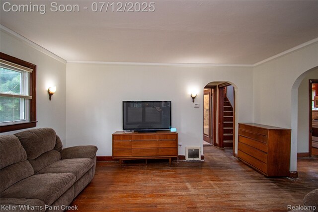 20525 30 Mile Rd, Ray, MI 48096 - living room with arched walkways, wood finished floors, ornamental molding, and stairs