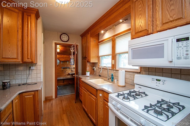 20525 30 Mile Rd, Ray, MI 48096 - kitchen with white appliances, light wood finished floors, backsplash, and brown cabinets