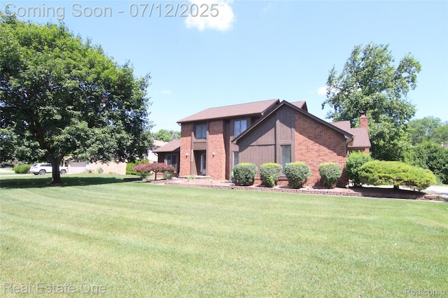 33234 Walnut Ln, Farmington Hills, MI 48334 - view of front of home featuring a front yard, a chimney, and brick siding