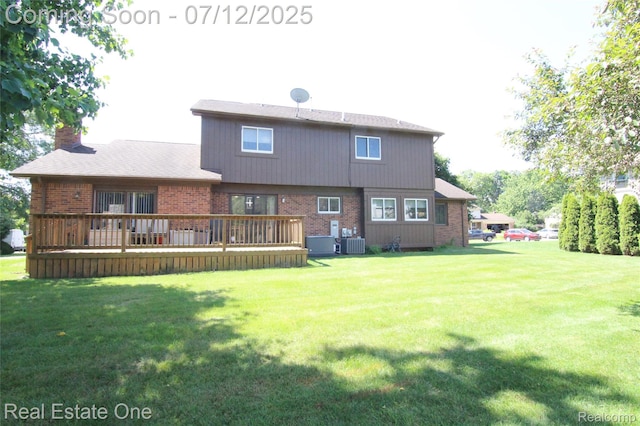 33234 Walnut Ln, Farmington Hills, MI 48334 - rear view of house featuring a lawn, a wooden deck, brick siding, and a chimney