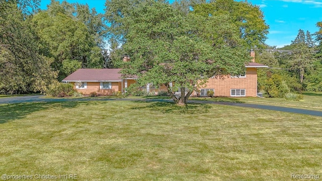 30700 Marimoor St, Beverly Hills, MI 48025 - view of front of property featuring a chimney and a front yard