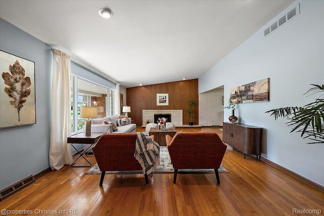 30700 Marimoor St, Beverly Hills, MI 48025 - living room featuring wood finished floors, a lit fireplace, and vaulted ceiling