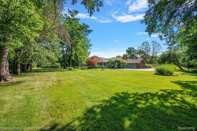 30700 Marimoor St, Beverly Hills, MI 48025 - view of green lawn with a playground